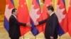 Cambodia's Prime Minister Hun Sen (L) stretches to shake hands with China's President Xi Jinping before a meeting at the Great Hall of the People in Beijing, November 7, 2014. REUTERS/Jason Lee/POOL