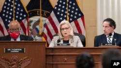 FILE - Rep. Liz Cheney, vice chair of the House panel investigating the Jan. 6 U.S. Capitol insurrection, is flanked by the panel's chairman, Rep. Bennie Thompson, and Rep. Jamie Raskin during a session of the panel at the Capitol in Washington, Dec. 13, 2021.