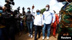 Ghana's President Nana Akufo-Addo gestures at a polling station during presidential and parliamentary elections in Kyebi, Ghana, Dec. 7, 2020.
