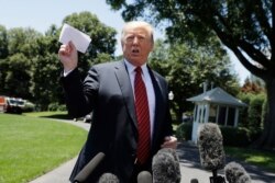 President Donald Trump speaks to reporters before departing for a trip to Iowa, on the South Lawn of White House.