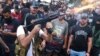 Supporters of the Shiite Amal group fire weapons in the air during the funeral processions of Hassan Jamil Nehmeh, who was killed during clashes the day before, in the southern Beirut suburb of Dahiyeh, Lebanon, Oct. 15, 2021.