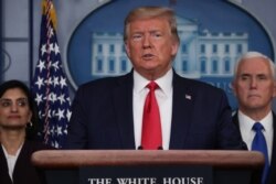 U.S. President Donald Trump addresses the daily coronavirus response briefing as Seema Verma, administrator of the Centers for Medicare & Medicaid Services, and Vice President Mike Pence look on at the White House in Washington, March 18, 2020.