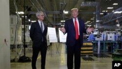Apple CEO Tim Cook and President Donald Trump speak during a tour of an Apple manufacturing plant, Nov. 20, 2019, in Austin, Texas. 