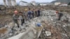 FILE - Workers recover cement blocks from flood-damaged areas in Onsong, North Hamgyong Province, North Korea, Sept. 16, 2016. Amid recent nuclear tensions, Pyongyang is struggling to secure aid for victims of flooding that occurred earlier this month.