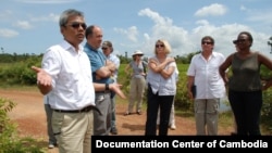 Youk Chhang, Elizabeth Becker and Michael ABRAMOWITZ, USHMM Director and his delegations at a B52 bomb pond near the Chinese airport, Kampong Chhnang province. Oct 24, 2012. Photo by Nhean Socheat.