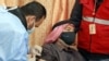 FILE - A mask-clad Jordan-based Syrian refugee receives a COVID-19 vaccination at a governmental medical center in Mafraq in northern Jordan, Jan. 18, 2021. 