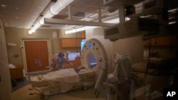 Charlie Stroiney, 8, is prepped for an MRI during a long day of testing at Children's National Hospital, in Washington. Charlie did not have COVID-19 but her sister, Lexie, 6, did.
