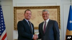 Kosovo President Hashim Thaci, right, shakes hands with President Donald Trump's envoy for the Kosovo-Serbia dialogue, Ambassador Richard Grenell, in Kosovo's capital of Pristina, Oct. 9, 2019.
