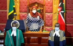 FILE - Tanzanian President Samia Suluhu Hassan (C) arrives to address a joint Parliament session of Kenyan Members of Parliament and Senators in Nairobi, Kenya, May 5, 2021.