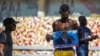 A man holds a photograph of Supreme Court Judge Joseph Mecene Jean-Louis during protests against Haiti's President Jovenel Moise, in Port-au-Prince, Haiti, Feb. 8, 2021. 