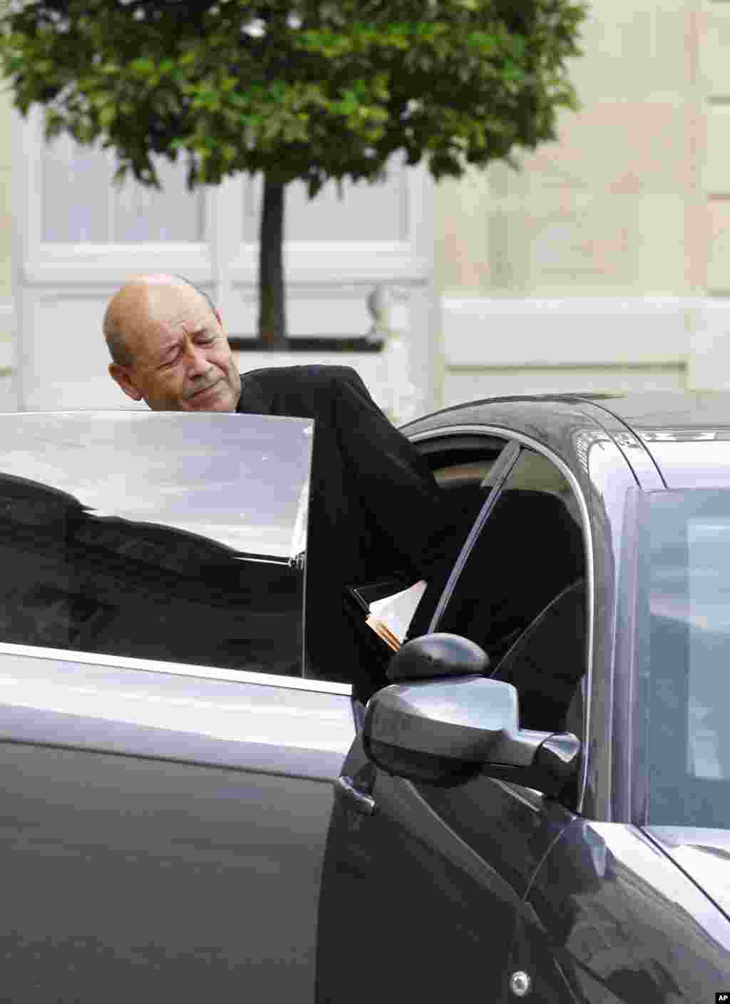 French Defense Minister Jean-Yves Le Drian gets into his car, as he leaves the Elysee Palace following a special defense meeting with French President Francois Hollande in Paris, Sept. 25, 2014.
