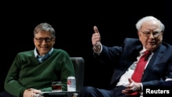 Warren Buffett, chairman and CEO of Berkshire Hathaway, speaks while Bill Gates looks on at Columbia University in New York, Jan. 27, 2017.