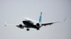 FILE - A Boeing 737 MAX airliner piloted by Federal Aviation Administration Administrator Steve Dickson lands following an evaluation flight at Boeing Field in Seattle, Sept. 30, 2020.