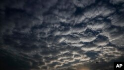 Sun sets behind a patterned cloud formed over the city in Kolkata, West Bengal state, India, Monday, May 18, 2020. A cyclonic storm 'Amphan' has intensified into a super cyclone over the Bay of Bengal and expected a landfall near Sundarbans, south…