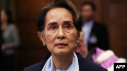 FILE - Myanmar's leader Aung San Suu Kyi arrives at the International Court of Justice in The Hague, Netherlands Dec. 11, 2019. A court in Myanmar postponed its verdict in the trial of ousted leader Suu Kyi to allow testimony from an additional witness.