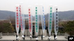  FILEIn this April 15, 2011, photo, North Korean refugee Park Sang Hak, center, and South Korean activists prepare to release balloons bearing leaflets North Korea's leader during an anti-North Korea rally.