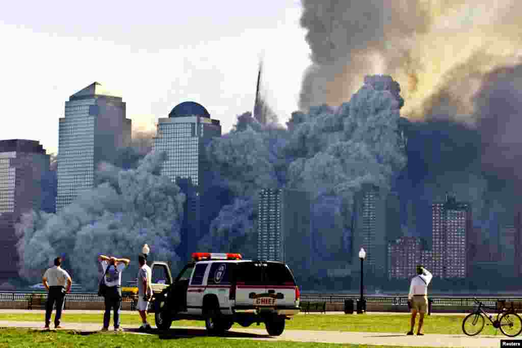 The remaining tower of New York&#39;s World Trade Center, Tower 2, dissolves in a cloud of dust and debris about a half hour after the first twin tower collapsed.