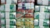  In this July 24, 2011, file photo, Sudan's new currency sits behind a window at the central bank in Khartoum, Sudan.