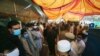 People stand outside a government office to get their identity cards verified to receive aid from the government during a nationwide lockdown to try to contain the outbreak of the coronavirus, in Peshawar, Pakistan, June 16, 2020. 