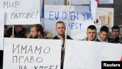FILE - People protest after Kosovo's decision to raise tariffs on Serbian and Bosnian goods, in the village of Rudare near Mitrovica, Kosovo, Nov. 23, 2018.