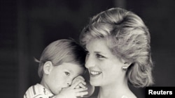 FILE - Britain's Princess Diana holds Prince Harry during a morning picture session at Marivent Palace, where the Prince and Princess of Wales are holidaying as guests of King Juan Carlos and Queen Sofia, in Mallorca, Spain August 9, 1988. 