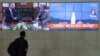 A man watches TV screens showing a photo of North Korea's weapon systems and South Korea's Foreign Minister Kang Kyung-wha meets with U.S. Special Representative for North Korea Stephen Biegun, top left, during news programs at the Yonhap News…