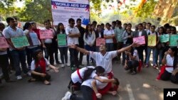 Students in New Delhi, India, prepare a street play about HIV and AIDS to mark World AIDS Day, Monday, December 1, 2014. (AP Photo/Saurabh Das)