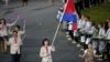 Cambodia's flagbearer Davin Sorn holds the national flag as she leads the contingent in the athletes parade during the opening ceremony of the London 2012 Olympic Games at the Olympic Stadium July 27, 2012. 