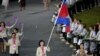 Cambodia's flagbearer Davin Sorn holds the national flag as she leads the contingent in the athletes parade during the opening ceremony of the London 2012 Olympic Games at the Olympic Stadium July 27, 2012. REUTERS/Mike Blake (BRITAIN - Tags: SPORT OLYMPICS) 