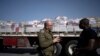 FILE - Israeli Army Colonel Moshe Tetro speaks to a journalist as trucks carrying humanitarian aid bound for the Gaza Strip wait in a holding area at Kerem Shalom Crossing on the border between Gaza and southern Israel on Jan. 10, 2024.