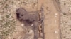 This satellite photo from Planet Labs PBC shows damaged aircraft, including one on fire, at Khartoum International Airport in Khartoum, Sudan, April 17, 2023. 