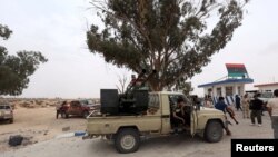 Fighters loyal to Libya's internationally recognized government are seen after taking control of Watiya airbase, southwest of Tripoli, May 18, 2020.