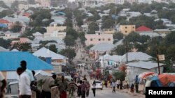 FILE - People walk along a street in Mogadishu, Somalia, Sept. 28, 2013. 
