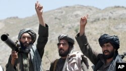 FILE - Taliban fighters listen to a speech by a senior leader in Shindand district of Herat province, Afghanistan, May 27 2016. 