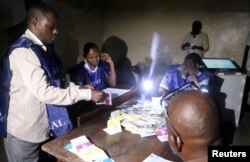 Officials of Congo's National Independent Electoral Commission (CENI) count cast ballots at a polling station in Kinshasa, Democratic Republic of Congo, Dec. 30, 2018.