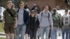 FILE - Students walk across campus at the University of Vermont in Burlington, Vermont. By the end of 2017, according to the Federal Reserve Bank, national student loan debt in the United States was $1.48 trillion. 