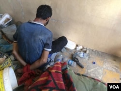 At an Iraqi base in Mosul, suspected IS militants are held before being transported to authorities, July 9, 2017. (H. Murdock/VOA)