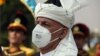 FILE - Afghan President Ashraf Ghani, wearing a mask to help curb the spread of the coronavirus, sings the national anthem at the Independence Minaret monument during the Independence Day celebrations in Kabul, Afghanistan, Aug. 18, 2020.