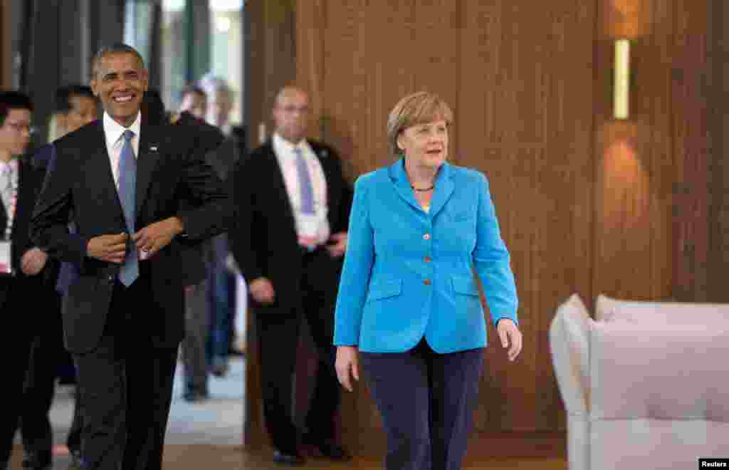 U.S. President Barack Obama and Germany's Chancellor Angela Merkel arrive for the first working session of a G7 summit at the hotel castle Elmau in Kruen, Germany, June 7, 2015.