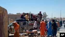Taliban fighters patrol inside the city of Farah, capital of Farah province, southwest Afghanistan, Aug. 11, 2021. 