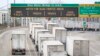 A line of trucks wait to cross the Bluewater Bridge border crossing between Sarnia, Ontario and Port Huron, Michigan on January 29, 2025.