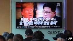 FILE - People watch a TV screen showing images of U.S. President Donald Trump, left, and North Korean leader Kim Jong Un during a news program at the Seoul Railway Station in Seoul, South Korea, May 25, 2018. 