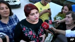 Azeri Khadija Ismayilova, a reporter for Radio Free Europe/Radio Liberty, speaks to journalists after her release from prison in Baku, Azerbaijan, May 25, 2016. 