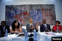 U.S. President Barack Obama attends a meeting with Cuban dissidents at the U.S. embassy in Havana, Cuba, March 22, 2016. On the wall behind Obama is a painting, "My New Friend," donated to the embassy by Michel Mirabal, a Cuban artist.