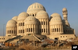 FILE - Iraq's special forces patrol near the grand mosque after defeating Islamic State militants on the eastern side of Mosul, Iraq, Jan. 19, 2017. It was from here that IS leader Abu Bakr al-Baghdadi appeared for the first time in public, delivering a sermon broadcast online by militants on July 15, 2014.