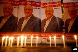 FILE - Candles, lit by activists protesting the killing of Saudi journalist Jamal Khashoggi, are placed outside Saudi Arabia's consulate in Istanbul, Oct. 25, 2018.