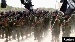FILE - Recruits belonging to Somalia's al Shabaab rebel group march during a parade at a training base in 2011.