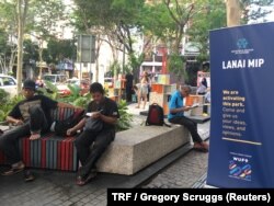 FILE - A group of people enjoy a new pop-up space in Kuala Lumpur's old city, Malaysia, February 2018.
