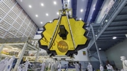 In this April 13, 2017 photo provided by NASA, technicians lift the mirror of the James Webb Space Telescope using a crane at the Goddard Space Flight Center in Greenbelt, Md. (Laura Betz/NASA via AP)