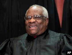 FILE - Associate Justice Clarence Thomas sits with fellow Supreme Court justices for a group portrait at the Supreme Court Building in Washington, Nov. 30, 2018.